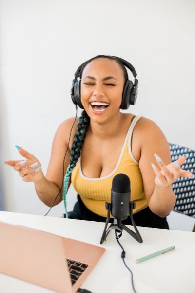 podcast presenter smiling with eyes shut