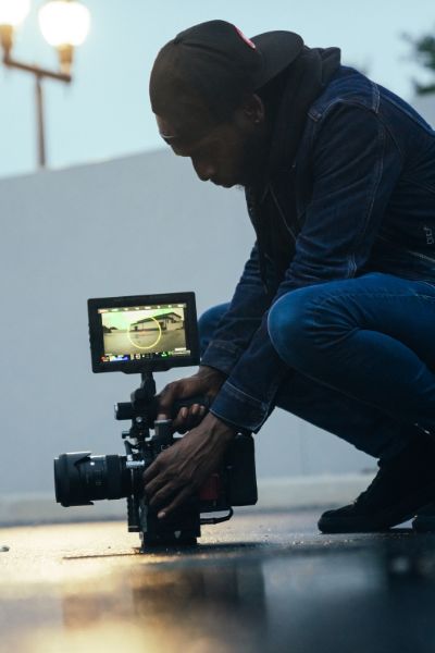 man setting up a video camera for a shooting